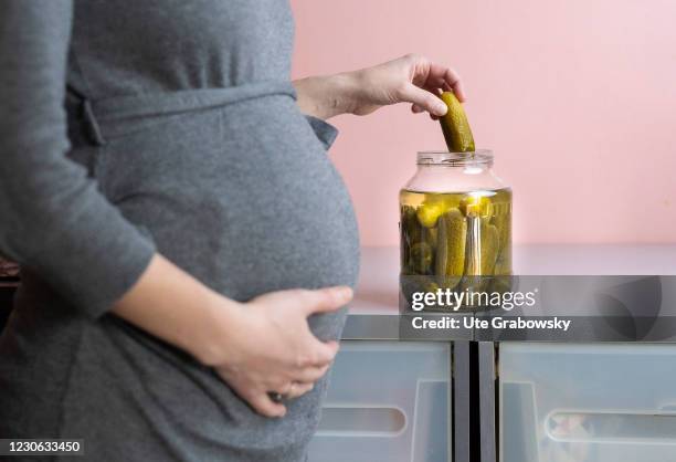 Bonn, Germany In this photo illustration a pregnant woman eats pickleson January 14, 2021 in Bonn, Germany.