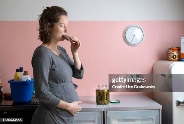Bonn, Germany In this photo illustration a pregnant woman eats chocolate on January 14, 2021 in Bonn, Germany.