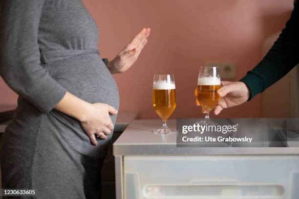 Bonn, Germany In this photo illustration refuses a woman to drink alcoholic beverages, a beer, on January 14, 2021 in Bonn, Germany.