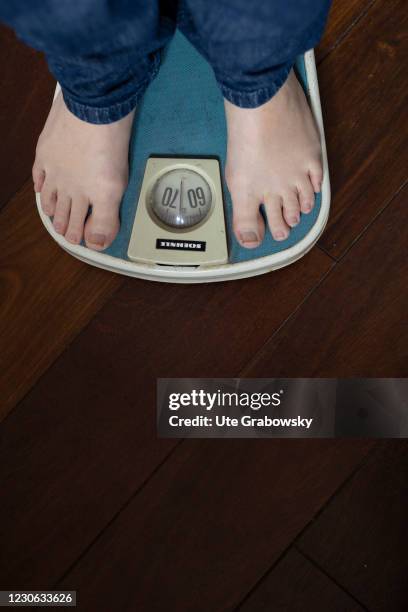 Bonn, Germany In this photo illustration a woman controls her weight on January 14, 2021 in Bonn, Germany.