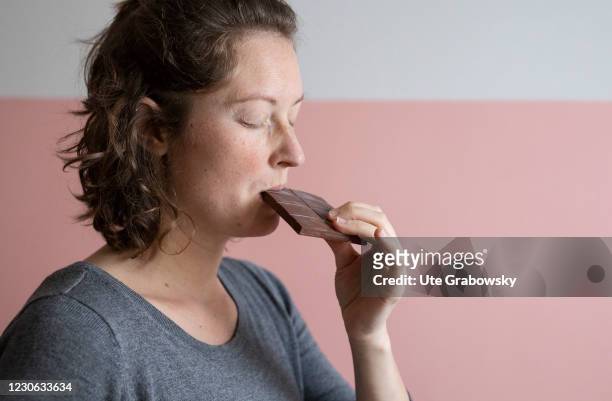 Bonn, Germany In this photo illustration a woman enjoys to eat chocolate on January 14, 2021 in Bonn, Germany.