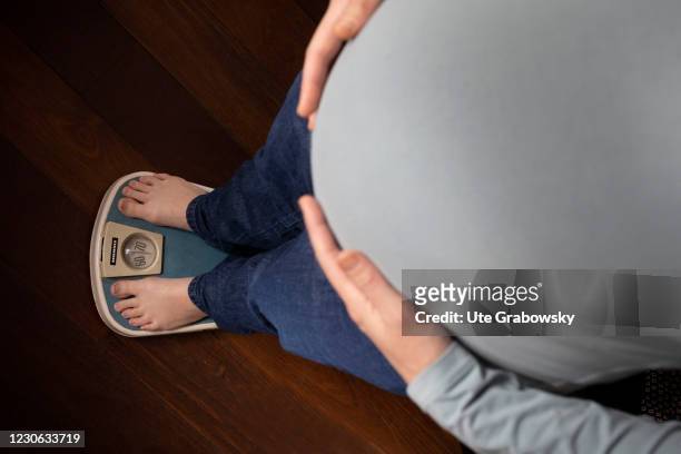 Bonn, Germany In this photo illustration a woman controls her weight on January 14, 2021 in Bonn, Germany.