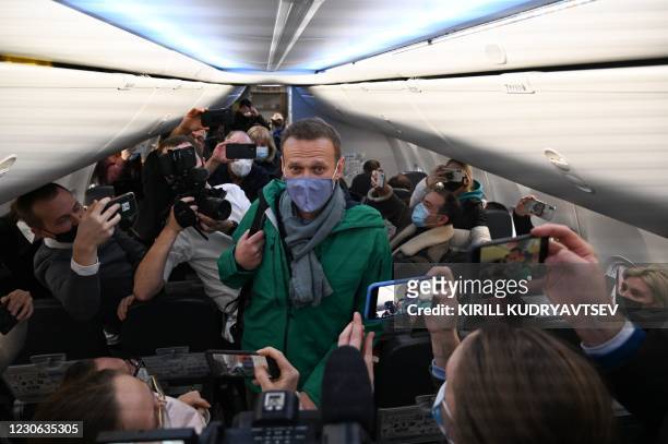 Russian opposition leader Alexei Navalny walks to take his seat in a Pobeda airlines plane heading to Moscow before take-off from Berlin Brandenburg...