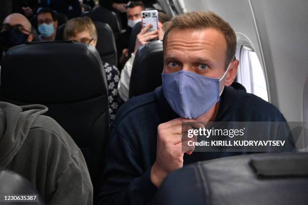 Russian opposition leader Alexei Navalny sits in a Pobeda airlines plane heading to Moscow before take-off from Berlin Brandenburg Airport in...