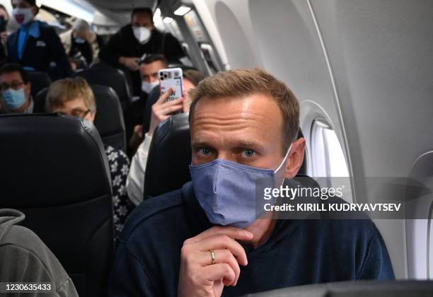 Russian opposition leader Alexei Navalny sits in a Pobeda airlines plane heading to Moscow before take-off from Berlin Brandenburg Airport in...