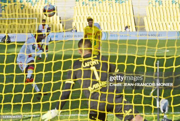 Lens' French Congolese defender Gael Kakuta scores a penalty to Nantes' French goalkeeper Alban Lafont during the French L1 Football match between FC...