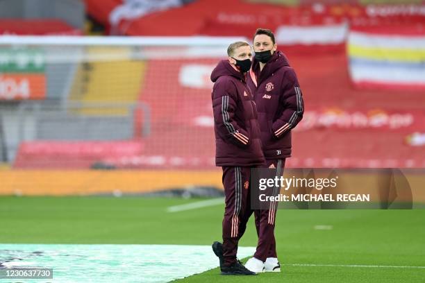 Manchester United's Dutch midfielder Donny van de Beek and Manchester United's Serbian midfielder Nemanja Matic wearing protective face coverings to...