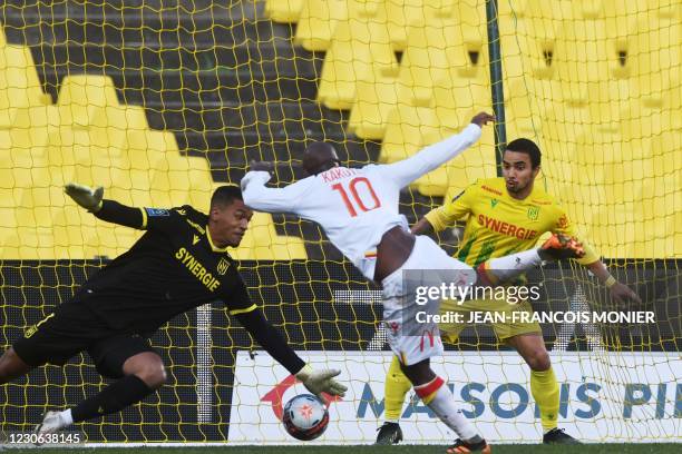 Lens' French Congolese defender Gael Kakuta scores Nantes' French goalkeeper Alban Lafont during the French L1 Football match between FC Nantes and...