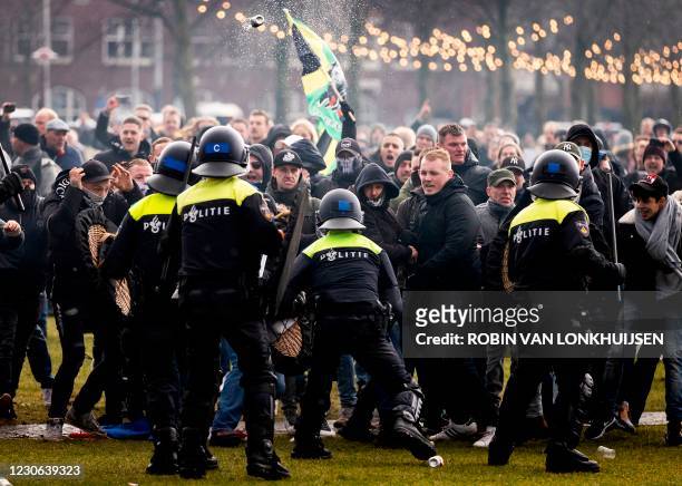 Anti-government activist face off with Dutch police during a protest to denounce ongoing restrictions related to the coronavirus disease pandemic in...