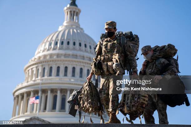 Members of the National Guard, outside the U.S. Capitol Building - a day after the House of Representatives impeached President Donald Trump, and...