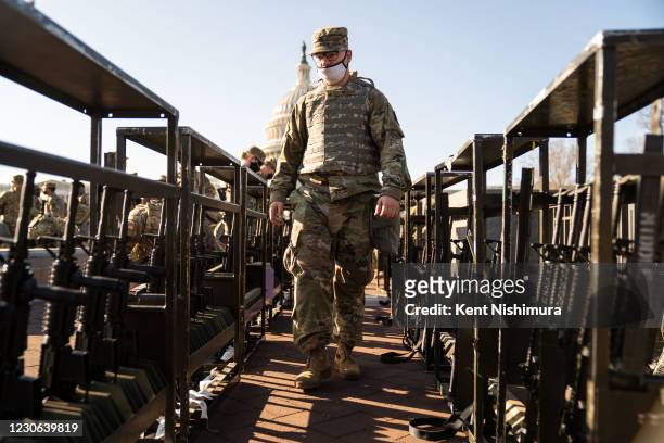 Members of the National Guard, outside the U.S. Capitol Building a day after the House of Representatives impeached President Donald Trump, and over...