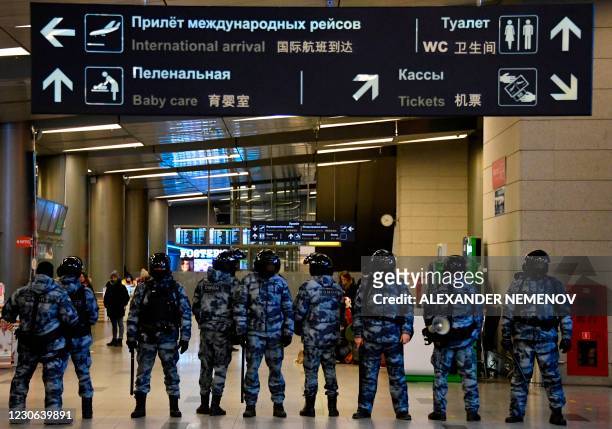 Riot police stand guard in the arrivals hall at Moscow's Vnukovo airport where Russian opposition leader Alexei Navalny is expected to arrive on...