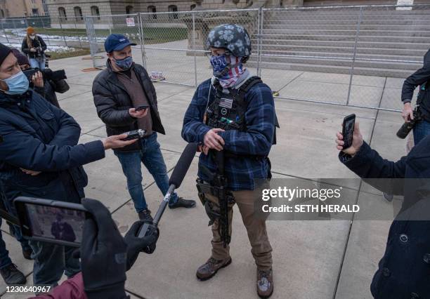 Member of the Boogaloo Boys an anti-government group speaks to members of the press in front the Capitol building in Lansing, Michigan on January 17...