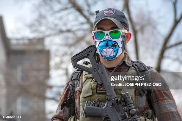 An armed member of the Boogaloo militia stands in front of the State Capital in Concord, New Hampshire on January 17 during a nationwide protest...