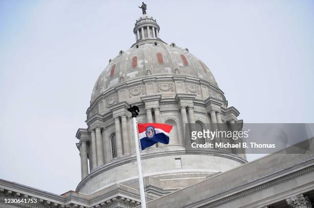 The Missouri state flag is seen flying outside the Missouri State Capitol Building on January 17, 2021 in Jefferson City, Missouri. Supporters of...