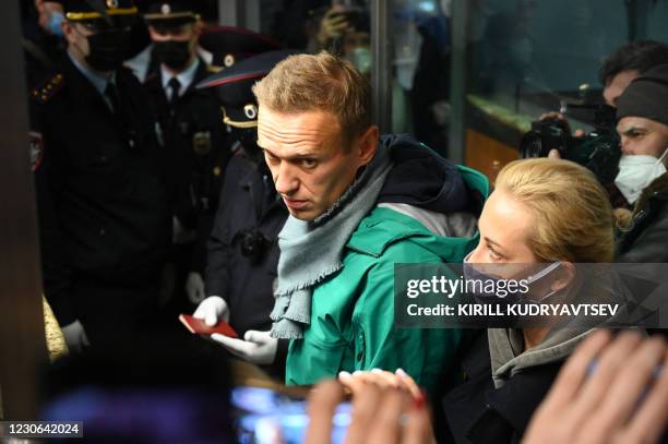 Russian opposition leader Alexei Navalny and his wife Yulia are seen at the passport control point at Moscow's Sheremetyevo airport on January 17,...