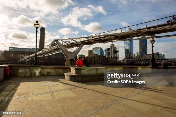 View of a couple beneath the millennium Bridge during the Covid-19 lockdown in London.