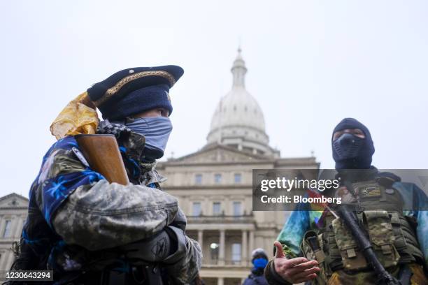 Armed members of the Boogaloo Boys movement outside the Michigan State Capitol in Lansing, Michigan, U.S., on Sunday, Jan. 17, 2021. A bulletin this...