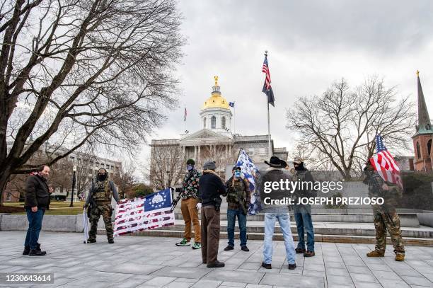 Armed members of the Boogaloo militia speak to people in front of the State Capital in Concord, New Hampshire on January 17 during a nationwide...