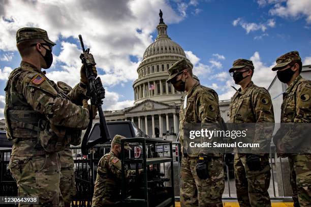 Virginia National Guard soldiers are issued their M4 rifles and live ammunition on the east front of the U.S. Capitol on January 17, 2021 in...