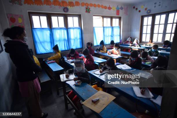 Primary School students of Bagh Bhairab Boarding High School taking their classes after nine months of complete closure due to COVID-19 pandemic fear...