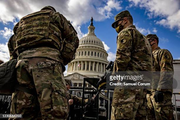 Virginia National Guard soldiers are issued their M4 rifles and live ammunition on the east front of the U.S. Capitol on January 17, 2021 in...