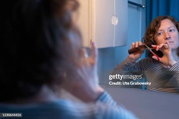 Bonn, Germany In this photo illustration a woman cuts her hair in times of a lockdown because of corona pandemic on January 17, 2021 in Bonn, Germany.