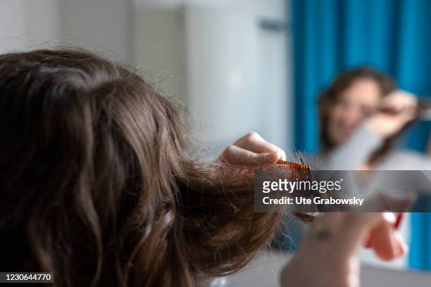 Bonn, Germany In this photo illustration a woman cuts her hair in times of a lockdown because of corona pandemic on January 17, 2021 in Bonn, Germany.