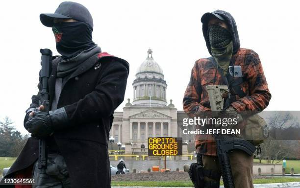 Members of the Boogaloo movement hold their rifles in front of the state capitol building in Frankfort, Kentucky, on January 17 during a nationwide...