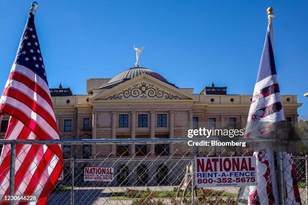 Boogaloo Boys movement flag, right, outside the Arizona State Capitol in Phoenix, Arizona, U.S., on Wednesday, Jan. 6, 2021. The House and Senate...