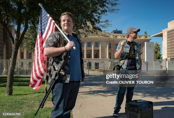 Members of the Boogaloo movement stand outside the Capitol Building in Phoenix, Arizona, on January 17, 2021 during a nationwide protest called by...