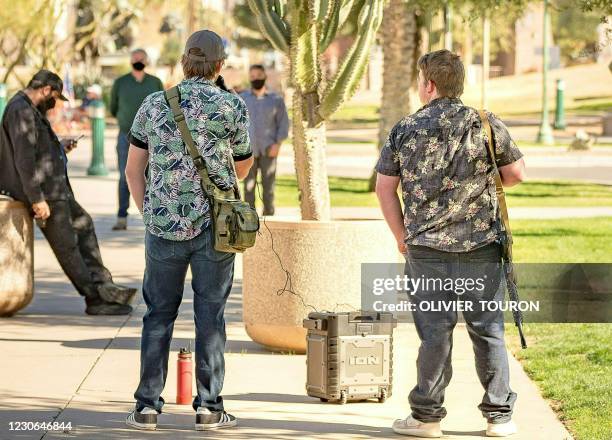 Members of the Boogaloo movement stand outside the Capitol Building in Phoenix, Arizona, on January 17, 2021 during a nationwide protest called by...