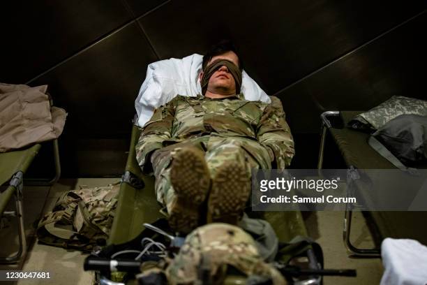 National Guard soldiers rest on cots in the Visitors Center of the U.S. Capitol on January 17, 2021 in Washington, DC. After last week's riots at the...