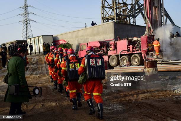 This photo taken on January 13, 2021 shows rescuers working at the site of gold mine explosion where 22 miners were trapped underground in Qixia, in...