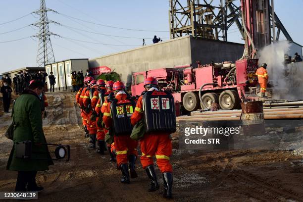 This photo taken on January 13, 2021 shows rescuers working at the site of gold mine explosion where 22 miners were trapped underground in Qixia, in...