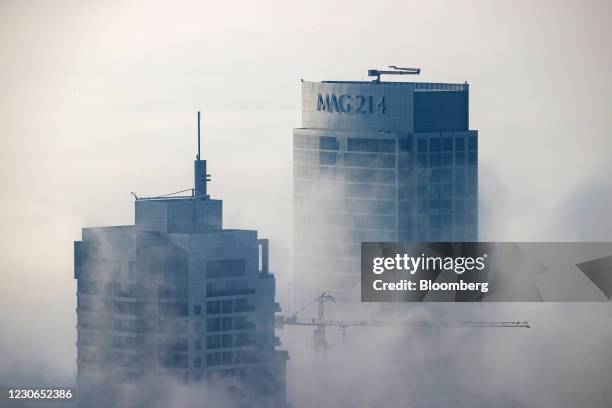 Residential and commercial skyscrapers stand among morning fog in the Jumeirah Lakes Towers district in Dubai, United Arab Emirates, on Sunday, Jan....