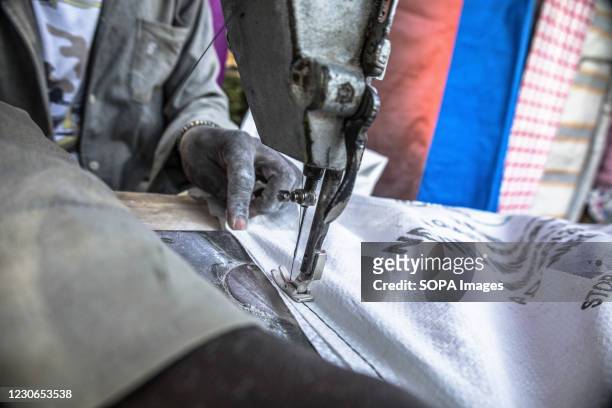 Year-old Simon Mulika is seen making carpets and tents for sale by the streets using recycled polypropylene sacks. In Africas largest and slowly...