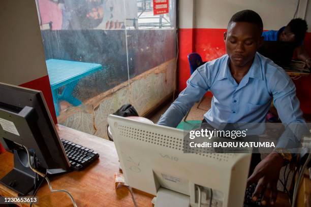 Man uses a computer at a cyber cafe minutes after the Uganda Communication Commission, a body responsible for communications in Uganda, restored the...