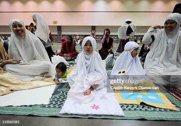 Samantha Sarwono and her daughters Yasyaa and Mutiara Sarwono , Muslims from Indonesia, gather with fellow Muslims for a special Eid ul-Fitr morning...