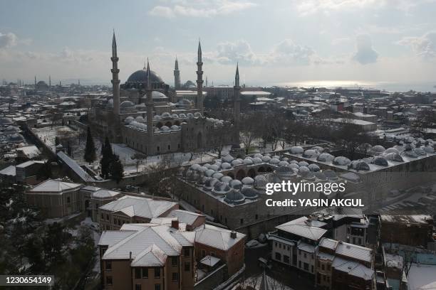 An aerial picture shows a view of Suleymaniye mosque covered with snow in the Balat District of Istanbul on January 18, 2021.