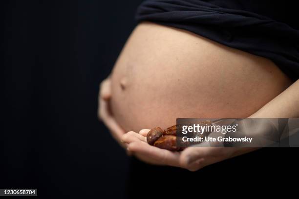 Bonn, Germany In this photo illustration a pregnant woman is showing her baby bump and some dates on January 17, 2021 in Bonn, Germany.