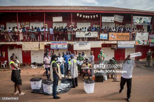 Voters gather to watch ballots being counted in Bugolobi, Kampala, on the afternoon of Uganda's presidential elections. Uganda's elections, on...