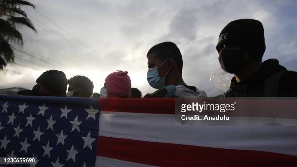 Migrants, who arrived in caravan from Honduras and try to make their way to the United States, wait at the border in Vado Hondo, Guatemala, on...