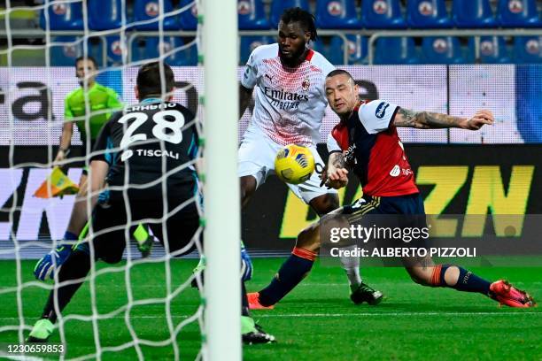 Milan's Ivorian midfielder Franck Kessie challenges Cagliari's Italian goalkeeper Alessio Cragno and Cagliari's Belgian midfielder Radja Nainggolan...