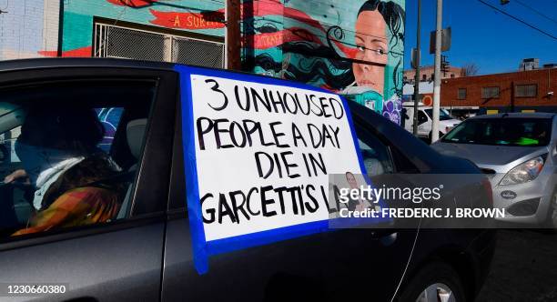 Sign commenting on the homeless situation in Los Angeles under Mayor Eric Garcetti is seen on a vehicle joining a car caravan demonstration on Martin...