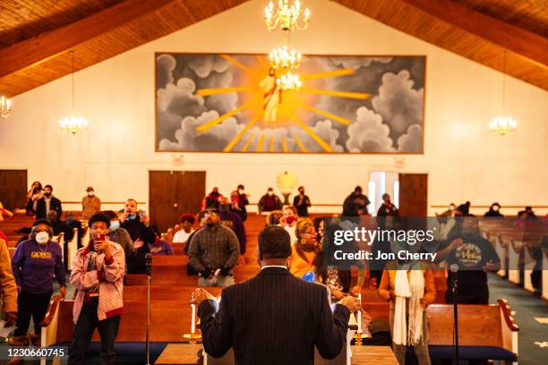 Churchgoers and protesters sing religious songs and observe Dr. Martin Luther King Jr. Day in King Solomon Missionary Baptist Church on January 18,...