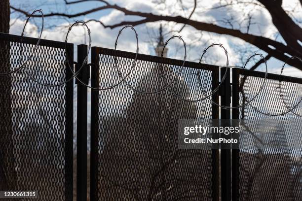 The US Capitol Building is seen behind barbed wire as security tightens ahead of presidential inaugural events in Washington, D.C. January 18, 2021.