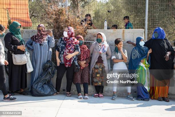 Women wearing facemasks are waiting seperately from men to get food. Humanitarian Aid is given to Asylum Seekers from Team Humanity Denmark NGO after...