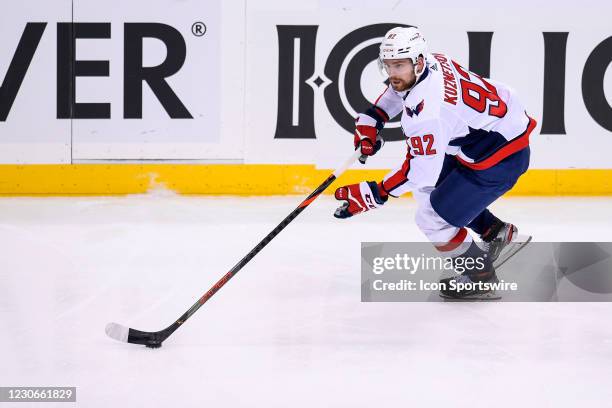 Washington Capitals Center Evgeny Kuznetsov skates with the puck during the third period in the NHL game between the Pittsburgh Penguins and the...