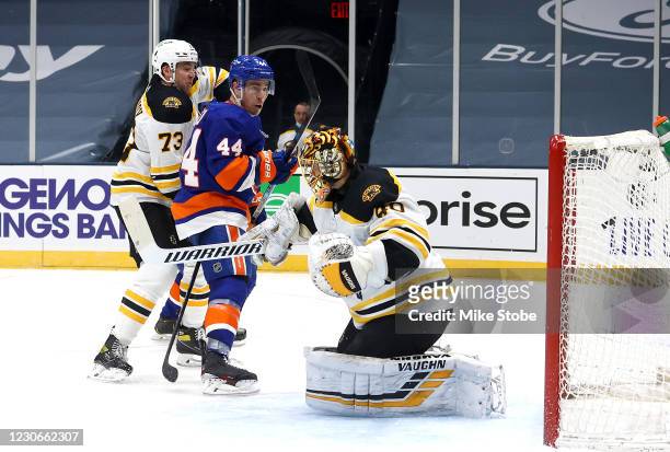 Jean-Gabriel Pageau of the New York Islanders scores a goal past Tuukka Rask of the Boston Bruins as Charlie McAvoy defends during the third period...